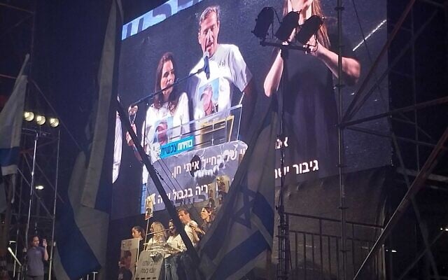 Ruby and Hagit Chen, the parents of slain IDF soldier Itay Chen, speak at Democracy Square in Tel Aviv, April 20, 2024. (Iddo Schejter/Times of Israel)