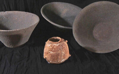 The restored, rare ivory vessel and the basalt stone containers it was buried in. (Emil Aladjem/IAA)