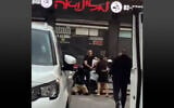 Off-duty policeman, in shorts, beats Yacoub Tukhi, in helmet, before shooting him to death, in Jaffa, April 12, 2024. (Screen capture: X, used in accordance with Clause 27a of the Copyright Law)