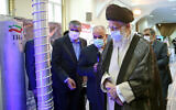 Iran's Supreme Leader Ayatollah Ali Khamenei (front) visits an exhibition of the country's nuclear industry achievements in Tehran, June 11, 2023, accompanied by the head of the Atomic Energy Organization of Iran Mohammad Eslami (L). (Khamenei.ir/AFP)