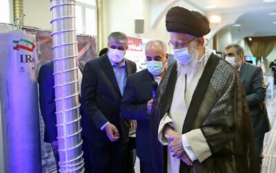 Iran's Supreme Leader Ayatollah Ali Khamenei (front) visits an exhibition of the country's nuclear industry achievements in Tehran, June 11, 2023, accompanied by the head of the Atomic Energy Organization of Iran Mohammad Eslami (L). (Khamenei.ir/AFP)