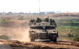 An Israeli army vehicle moves along the Gaza border, March 19, 2024. (Jack Guez / AFP)