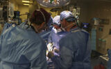In this March 16, 2024, image courtesy of the Massachusetts General Hospital in Boston, Massachusetts, surgeons perform the world's first genetically modified pig kidney transplant into a living human. (Michelle Rose/Massachusetts General Hospital/AFP)