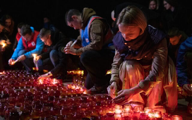 File - People light candles during a memorial gathering in Donetsk, Russian-controlled Ukraine, on March 24, 2024, as Russia observes a national day of mourning after a Moscow concert hall massacre that killed more than 130 people. (Valery Melnikov/AFP)