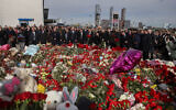 Ambassadors and representatives of diplomatic missions accredited in Russia stand at attention as they attend a flower laying ceremony at the memorial in memory of the victims of the terrorist attack at the Crocus City Hall concert venue a week after the attack in Krasnogorsk, outside Moscow on March 30, 2024. (SERGEI ILNITSKY / POOL / AFP)