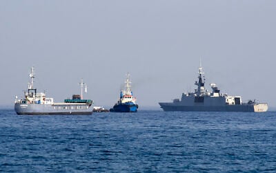 File: The barge Jennifer, part of a three ship flotilla carrying food aid for the Gaza Strip, sails next to the French frigate Courbet as the flotilla departs the port of Larnaca in Cyprus on March 30, 2024. (Iakovos Hatzistavrou/AFP)