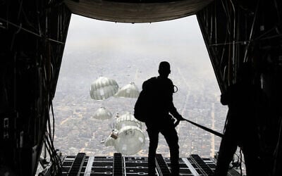 This handout picture released by the Jordanian army on March 31, 2024, shows humanitarian aid being airdropped from a military aircraft over the northern Gaza Strip. (Photo by Jordanian army / AFP)