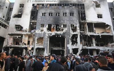 Palestinians inspect the damage outside Gaza's Shifa hospital after the Israeli military withdrew from the complex housing the hospital on April 1, 2024. (Photo by AFP)