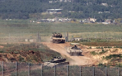 Israeli army vehicles move in an area along the border with the Gaza Strip and southern Israel on April 4, 2024. (Jack Guez/AFP) Israeli army vehicles move in an area along the border with the Gaza Strip and southern Israel on April 4, 2024. (Jack Guez/AFP)