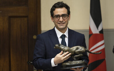 French Foreign Minister Stephane Sejourne poses with a gift in Nairobi, on April 6, 2024. (Simon Maina/AFP)