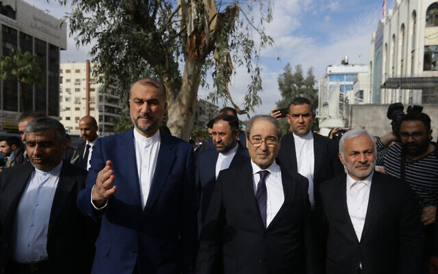 Iranian Foreign Minister Hossein Amir-Abdollahian (CL) walks alongside his Syrian counterpart Faisal Mekdad (CR) and Iran's Ambassador to Syria Hossein Akbari (C) during a visit to the site of a consular annex to the Iranian embassy destroyed in strikes, before inaugurating a new consular building nearby in Damascus on April 8, 2024. (Louai Beshara/AFP)