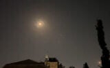 This video grab from AFPTV taken on April 14, 2024, shows explosions lighting up Jerusalem sky as Israeli air defenses respond to an Iranian attack on Israel. (AFPTV/AFP)