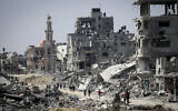People walk amid the rubble of buildings destroyed during the Israeli bombardment of Khan Yunis, in the southern Gaza Strip, on April 16, 2024.,(Photo by AFP)
