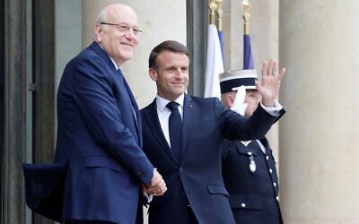 French President Emmanuel Macron (R) welcomes Lebanese Prime Minister Najib Mikati (L) before a meeting at the Elysee Palace in Paris on April 19, 2024. (Ludovic Marin/AFP)