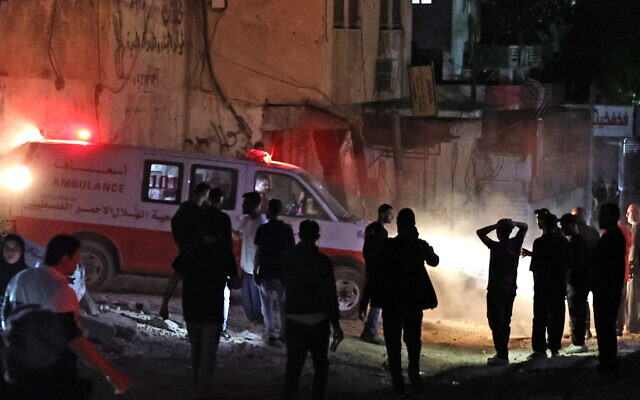 Palestinians gather next to an ambulance following an IDF raid in the Nur Shams refugee camp in the West bank on April 20, 2024. (Zain Jaafar/AFP)