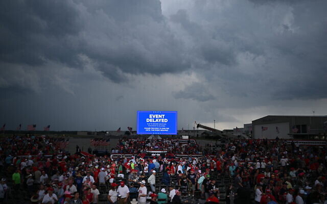 Supporters of former US president and 2024 Republican presidential candidate Donald Trump are asked to move to a shelter as a storm moves in before Trump was due to speak, at a campaign rally in Wilmington, North Carolina, April 20, 2024. (Jim Watson/AFP) Supporters of former US president and 2024 Republican presidential candidate Donald Trump are asked to move to a shelter as a storm moves in before Trump was due to speak, at a campaign rally in Wilmington, North Carolina, April 20, 2024. (Jim Watson/AFP)