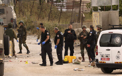 Israeli security forces cordon off the site of a reported attack at the Beit Einun junction, east of the West Bank city of Hebron on April 21, 2024. (HAZEM BADER / AFP)