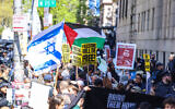 Pro-Palestinian and pro-Israel demonstrators face off in front of the entrance of Columbia University, which is occupied by pro-Palestinian protesters in New York on April 22, 2024. One of the pro-Palestinian demonstrators is holding up a poster of Zakaria Zubeidi, a notorious Fatah commander convicted of masterminding terror attacks during the Second Intifada. (Photo by Charly TRIBALLEAU / AFP)