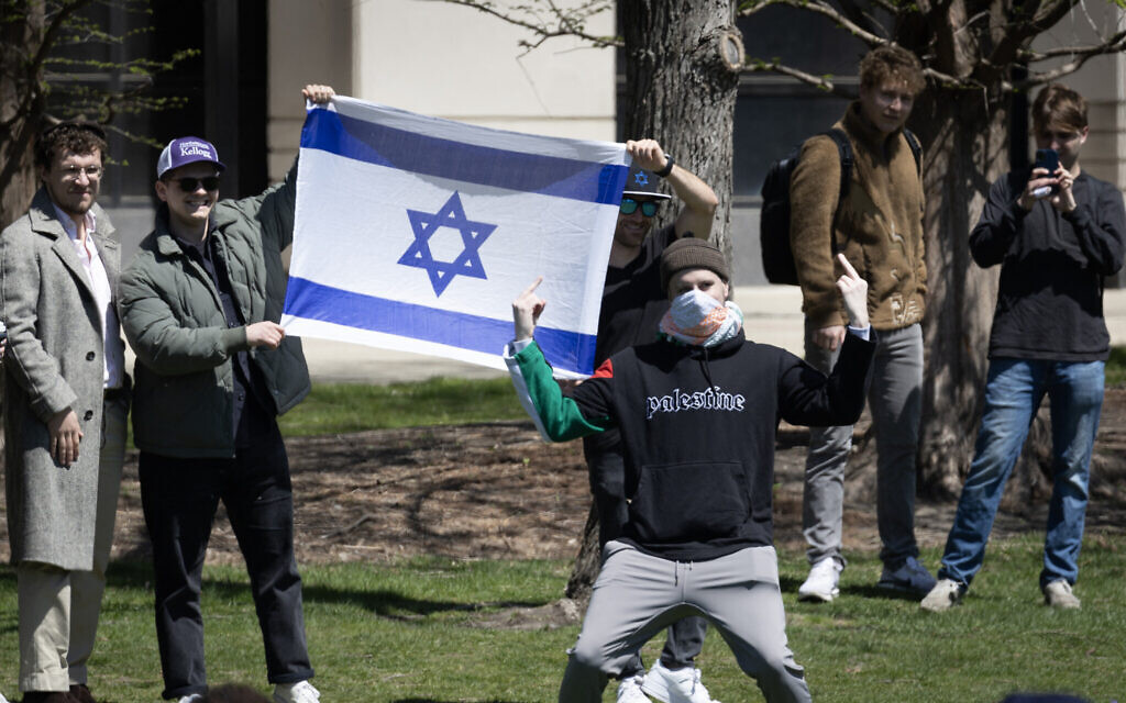 An anti-Israel protester gives the finger in front of counter-demonstrators holding an Israeli flag outside the Gaza Solidarity Encampment on the campus of Northwestern University on April 25, 2024 in Evanston, Illinois. (Scott Olson/Getty Images/AFP) An anti-Israel protester gives the finger in front of counter-demonstrators holding an Israeli flag outside the Gaza Solidarity Encampment on the campus of Northwestern University on April 25, 2024 in Evanston, Illinois. (Scott Olson/Getty Images/AFP)