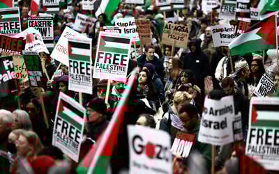 Pro-Palestinian supporters hold placards and wave Palestinian flags during a demonstration against Israel outside Westminster Palace in central London, on April 27, 2024. (Benjamin Cremel/AFP)