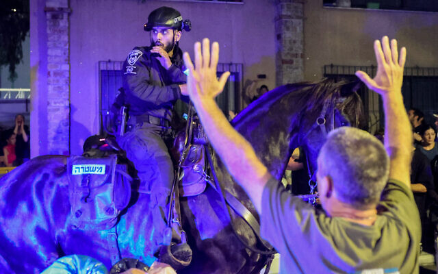 Israeli mounted police disperse anti-government demonstrators in Tel Aviv on April 27, 2024, amid the ongoing conflict between Israel and Hamas. (Jack Guez/AFP)