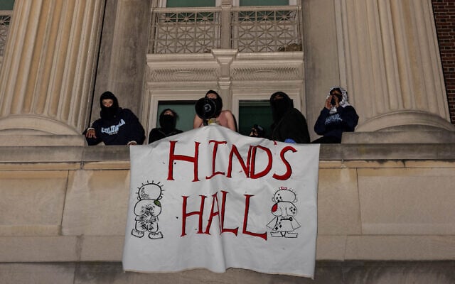 Demonstrators from Columbia University's pro-Palestinian, anti-Israel encampment unfurl a banner as they barricade themselves inside Hamilton Hall, a campus building which has been occupied in past student movements, and name it after a Palestinian child allegedly killed in Gaza, April 30, 2024 in New York City. (Alex Kent/Getty Images North America/Getty Images via AFP)