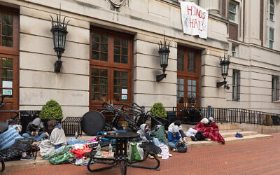 Anti-Israel student protesters sit outside of the occupied Hamilton Hall at Columbia University in New York City on April 30, 2024. (Emily Byrski/AFP)