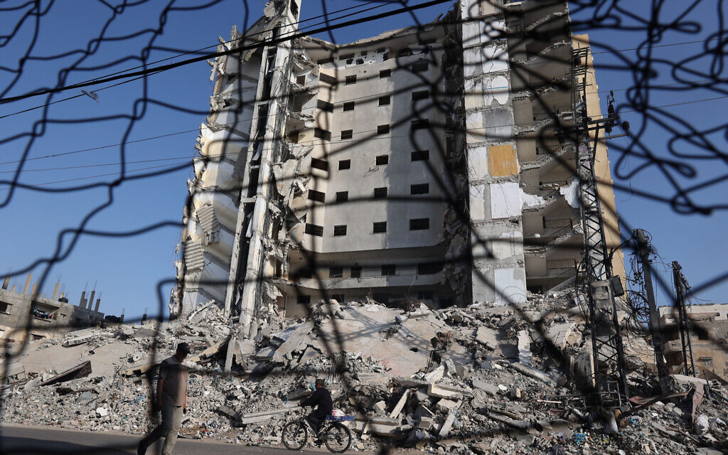 A Palestinian man walks past the rubble of buildings in Rafah, in the southern Gaza Strip, on April 30, 2024. (AFP)