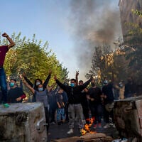 In this photo taken by an individual not employed by the Associated Press and obtained by the AP outside Iran, Iranians protests the death of 22-year-old Mahsa Amini, in Tehran, Iran, October 27, 2022. (AP Photo)