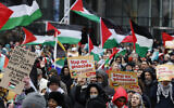 Demonstrators hold signs and wave flags during a pro-Palestinian, anti-Israel rally in Brussels on January 21, 2024. (AP/Geert Vanden Wijngaert)