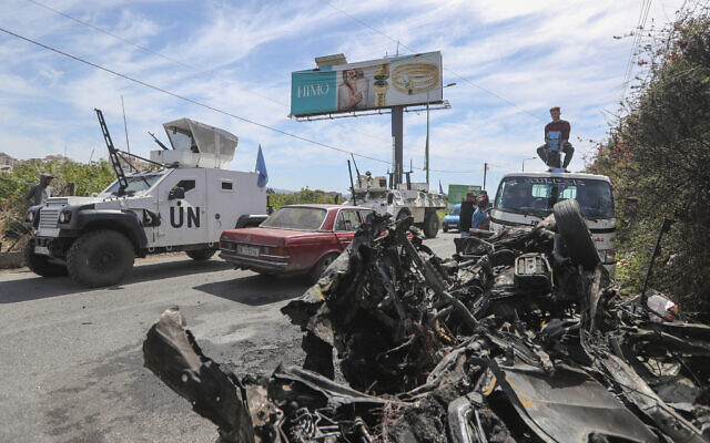 Illustrative: A UN peacekeeper vehicle passes next to a destroyed car in the southern outskirts of Tyre, Lebanon, March 13, 2024. (AP Photo/Mohammad Zaatari) Illustrative: A UN peacekeeper vehicle passes next to a destroyed car in the southern outskirts of Tyre, Lebanon, March 13, 2024. (AP Photo/Mohammad Zaatari)