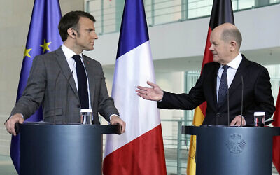German Chancellor Olaf Scholz (R) talking to French President Emmanuel Macron at a press conference in Berlin, Germany, March 15, 2024. (AP Photo/Ebrahim Noroozi)