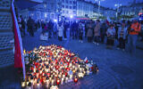 Friends and residents gather to place candles and flowers in honor of Damian Soból, a Polish food aid worker who was killed with six other World Central Kitchen workers by an Israeli airstrike in Gaza this week, in Soból's hometown of Przemysl, in southeastern Poland, April 4, 2024. (AP Photo)