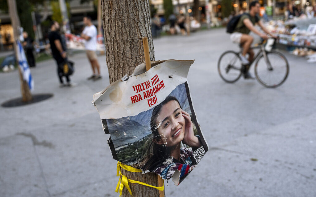 A poster depicting Israeli hostage Noa Argamani, 26, is displayed next to a memorial in Tel Aviv, April 4, 2024. (AP Photo/Oded Balilty)