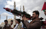 A Houthi supporter holds a mock missile during a protest marking Jerusalem Day in support of Palestinians in the Gaza Strip, in Sanaa, Yemen, April 5, 2024. (AP Photo/Osamah Abdulrahman)