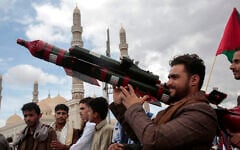 A Houthi supporter holds a mock missile during a protest marking Jerusalem Day in support of Palestinians in the Gaza Strip, in Sanaa, Yemen, April 5, 2024. (AP Photo/Osamah Abdulrahman)