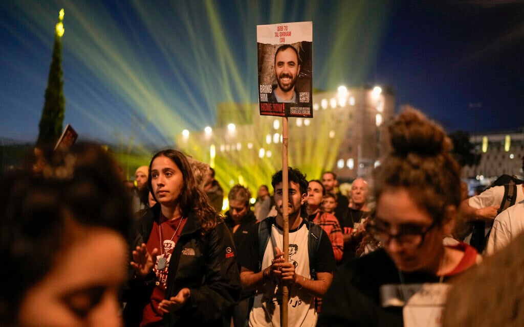 Demonstrators call on the government to secure the release of hostages held by terror groups in the Gaza Strip, during a rally marking six months since the outbreak of war against Hamas, outside the Knesset, Jerusalem, April 7, 2024. (AP Photo/Leo Correa)