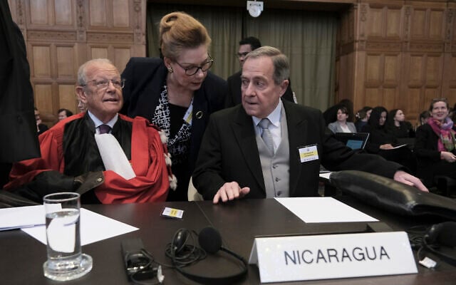 Nicaragua's Ambassador Carlos Jose Arguello Gomez, right, and Alain Pellet, lef, a lawyer representing Nicaragua, wait for the start of a two days hearing at the World Court in The Hague, Netherlands, Monday, April 8, 2024 (AP Photo/Patrick Post)