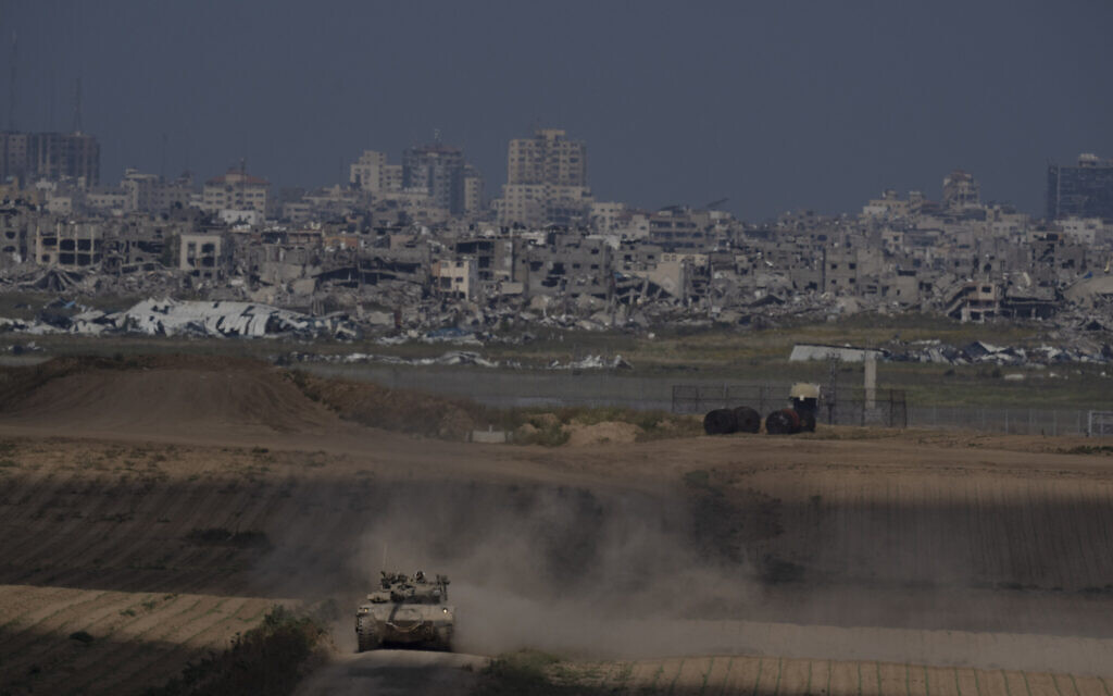 A tank moves near the Israeli-Gaza border, as seen from southern Israel, Tuesday, April 9, 2024. (AP/Leo Correa)