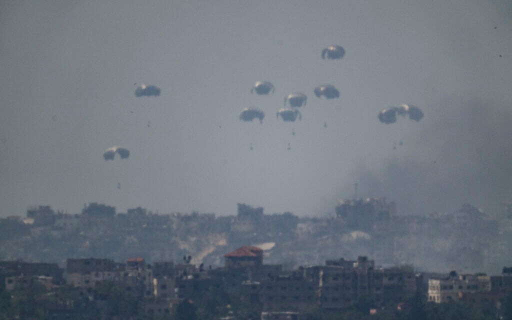 Parachutes drop supplies into the northern Gaza Strip as seen from southern Israel, April 9, 2024. (AP Photo/Leo Correa)