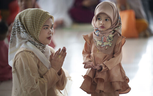 A Muslim woman shows her daughter how to pray as they attend prayers at National Mosque for the Eid al-Fitr, marking the end the holy fasting month of Ramadan in Kuala Lumpur, Malaysia, April 10, 2024. (Vincent Thian/AP) A Muslim woman shows her daughter how to pray as they attend prayers at National Mosque for the Eid al-Fitr, marking the end the holy fasting month of Ramadan in Kuala Lumpur, Malaysia, April 10, 2024. (Vincent Thian/AP)