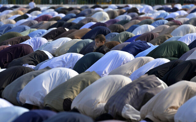 A Muslim child stands beside his father performing an Eid al-Fitr prayer with others, marking the end of the fasting month of Ramadan, in Rawalpindi, Pakistan, April, 10, 2024. (Anjum Naveed/AP) A Muslim child stands beside his father performing an Eid al-Fitr prayer with others, marking the end of the fasting month of Ramadan, in Rawalpindi, Pakistan, April, 10, 2024. (Anjum Naveed/AP)