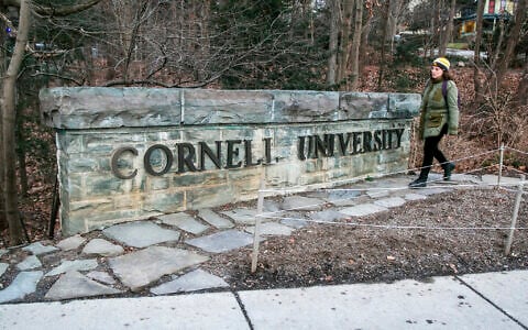 FILE - A woman walks by a Cornell University sign on the Ivy League school's campus, Jan. 14, 2022, in Ithaca, New York. (AP Photo/Ted Shaffrey, File)