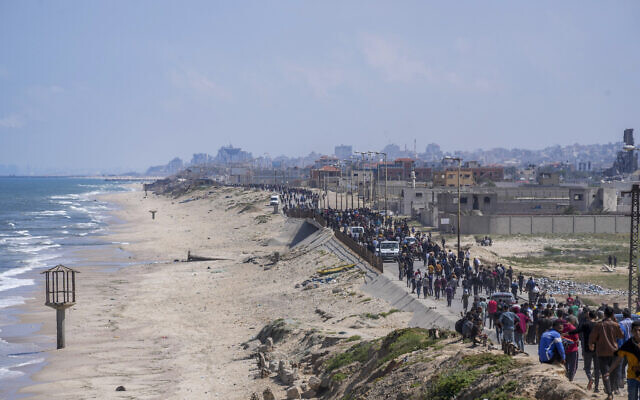 Displaced Palestinians trying to walk back from central Gaza Strip to northern Gaza Strip, Sunday, April 14, 2024. (AP Photo/Abdel Kareem Hana)