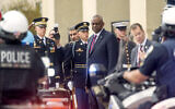 US Secretary of Defense Lloyd Austin watches a motorcade pass as he prepares to welcome Iraqi Prime Minister Mohammed Shia al-Sudani at the Pentagon on Monday, April 15, 2024, in Washington. (AP Photo/Kevin Wolf)