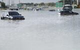 Vehicles sit abandoned in floodwater covering a major road in Dubai, United Arab Emirates, April 17, 2024. (Jon Gambrell/AP)