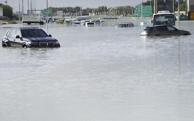 Vehicles sit abandoned in floodwater covering a major road in Dubai, United Arab Emirates, April 17, 2024. (Jon Gambrell/AP)