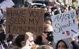 University of Southern Californian students carry signs protesting the cancelation of a commencement speech by the institution's 2024 valedictorian who has publicly supported Palestinians during Israel's war in Gaza, been accused of antisemitism and shared virulently anti-Israel content, on the USC campus in Los Angeles, California, April 18, 2024. (AP Photo/Damian Dovarganes)