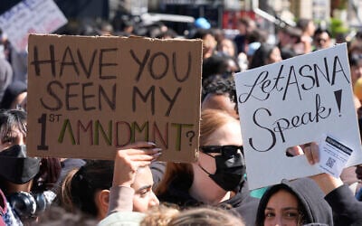 University of Southern Californian students carry signs protesting the cancelation of a commencement speech by the institution's 2024 valedictorian who has publicly supported Palestinians during Israel's war in Gaza, been accused of antisemitism and shared virulently anti-Israel content, on the USC campus in Los Angeles, California, April 18, 2024. (AP Photo/Damian Dovarganes)