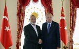 Turkey's President Recep Tayyip Erdogan, right, and slain Hamas leader Ismail Haniyeh, shake hands during their meeting in Istanbul, Turkey, April 20, 2024. (Turkish Presidency via AP)